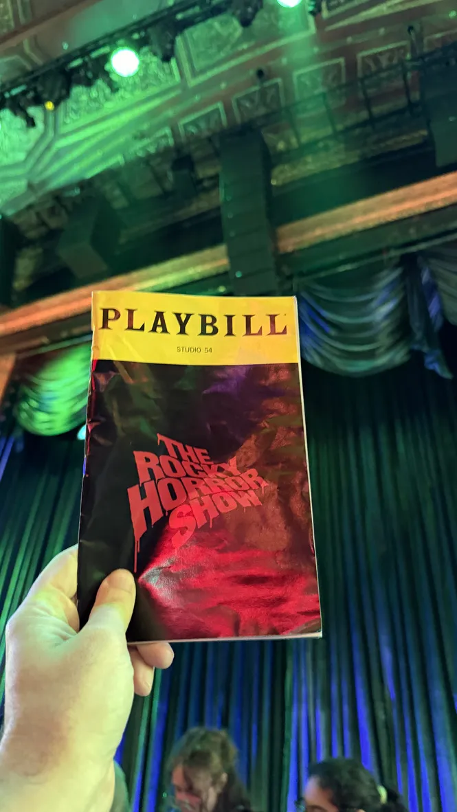 The Rocky Horror Show Playbill held up in front of the stage at Studio 54